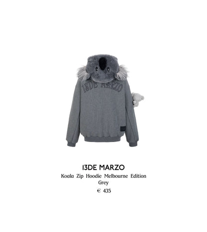 Grey hoodie with koala design and '13DE MARZO' branding on a white background
